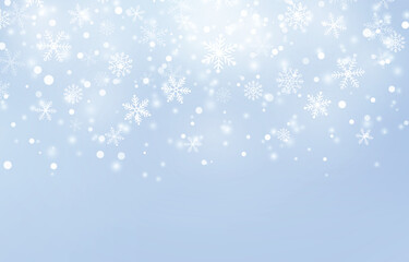 Falling snowflakes on a light blue background with a soft, blurred effect, creating a wintery and magical scene.