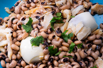 Delicious Portuguese dish of feijão frade (black-eyed peas) with bacalhau (cod) and a perfectly...
