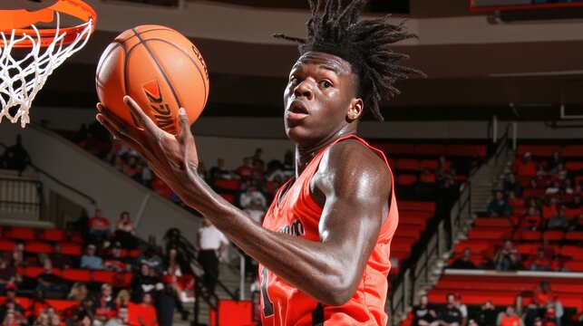 Young basketball player soaring for a layup, showcasing his athleticism and passion for the sport.