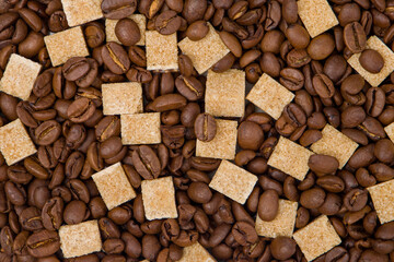 Coffee beans and brown sugar cubes background. Close up.