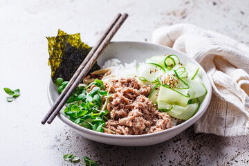Spicy tuna sushi bowl with rice, nori and cucumber.