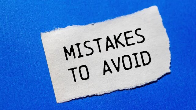 Mistakes to avoid message writing on ripped torn paper piece on blue background. Conceptual mistakes to avoid symbol.