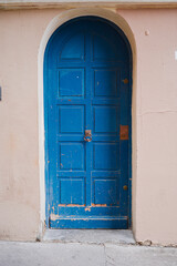 Weathered Blue Arch Door Closing the Entry of a Old Building