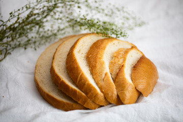Fresh Sliced White sourdough bread on background with herbs