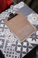 Table with a Empty Wooden Clipboard on Top