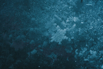 Macro picture of snow with crystals in good view dark background. Natural snowflakes on snow. Photo of real snowflakes during a snowfall, under natural conditions at low temperature.