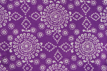 Vintage fabric purple with small geometric white pattern. Part of a cotton scarf.