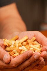 Unhealthy food. Croutons. Unhealthy food for figure, heart, skin, teeth. Fast carbohydrates. Wooden background. Salty snack for beer. Junk food. Fast food. Snack. Cholesterol.