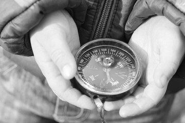 Old classic navigation compass in hands