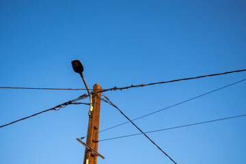 electric pole facing the late afternoon sky