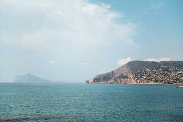 Coastal mountain view with serene sea and blue sky
