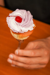 Tasty baking cupcakes, cake or muffin with pink cream icing, frosting. Bakery. Confectionery. Cupcake decoration. Cherry on top. Cupcake. Birthday cupcake with cherry on top. Happy Birthday. Eating.