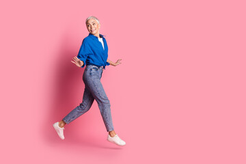 Full length photo of cheerful pretty lady dressed blue shirt running having fun empty space...