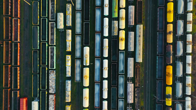 Aerial view of freight trains parked in a railway yard. An aerial shot of a railway yard filled with an organized array of freight trains.