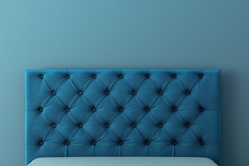 Stylish blue tufted headboard against a light blue wall in a modern bedroom interior