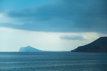 Dramatic coastal landscape with serene ocean and distant skyline