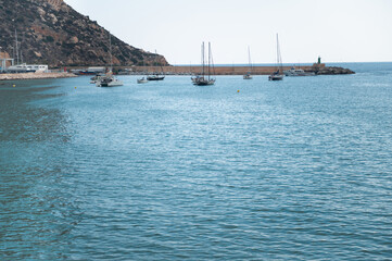 Scenic coastal view with sailboats in a tranquil marina