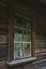 An old window of an Old Slavic, rustic house. Wooden house