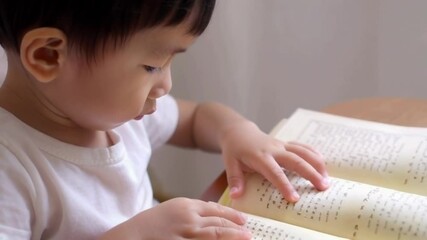 slow motion video of child learning to read a Braille book