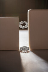 Jewelry with precious stones. Jewelry made of silver and stones on a paper box. Rings made of metal...