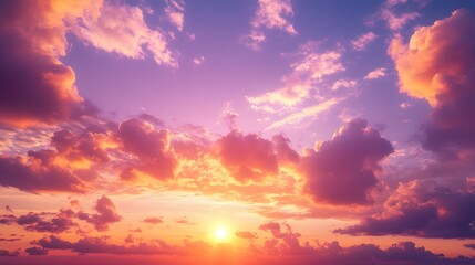 Fototapeta premium A sunset sky filled with vibrant purple and pink clouds during golden hour, showcasing a dramatic cloudscape with warm tones and a serene evening atmosphere in a panoramic view.