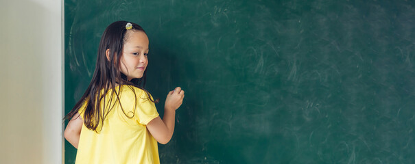 Girl is study in the Classroom. Back to school! Cute industrious children are sitting at desks indoors. Kids are learning in class.