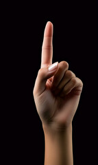 An illuminated hand raising the index finger, isolated against a pure black background, symbolizing command or instruction
