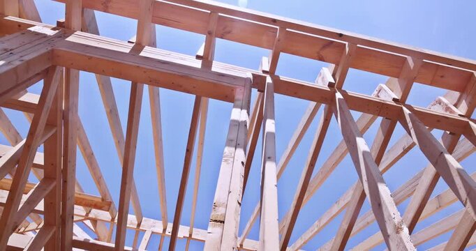 Installation of timber roofing truss frames by building under construction roof