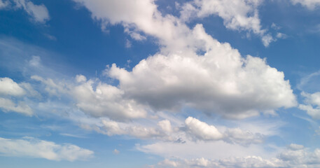 Beautiful blue sky with fluffy white clouds creating a serene atmosphere. Perfect for backgrounds, nature themes, or weather-related content.