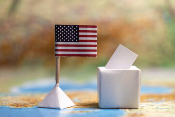 The flag of the USA and next to the box with the acceptance of votes at the elections. Elections in...