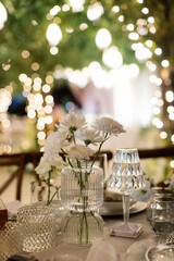 Compositions of white flowers on the festive table