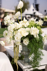Compositions of white flowers on the festive table