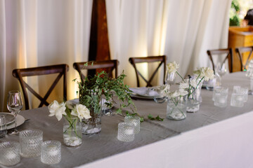 Compositions of white flowers on the festive table