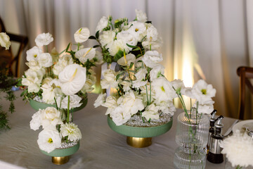 Compositions of white flowers on the festive table