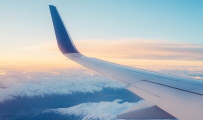 Aerial View of Snowy Mountains and Airplane Wing During Sunset