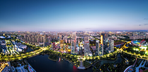 Naklejka premium Captivating Cityscape at Dusk: Urban Lights Reflecting on Water