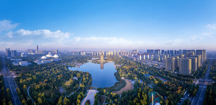 Expansive Aerial View of a Modern Urban Landscape with Serene Lake