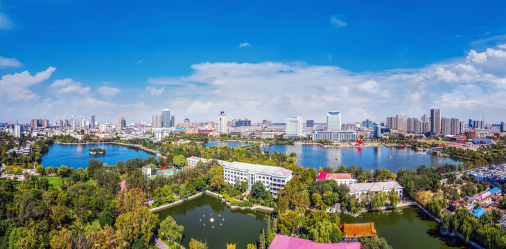 Scenic Aerial View of Urban Lake Surrounded by Parks and Skyline