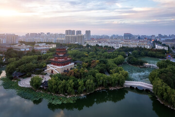 Fototapeta premium Aerial View of a Serene Urban Landscape with Pagoda and Lush Greenery