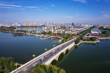 Aerial View of a Vibrant Cityscape with a Scenic Bridge Over Water