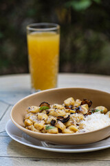 Pappardelle pasta with mushrooms and parmesan cheese on a plate . Traditional Italian gnocchi pasta with mushroom and parmesan cheese