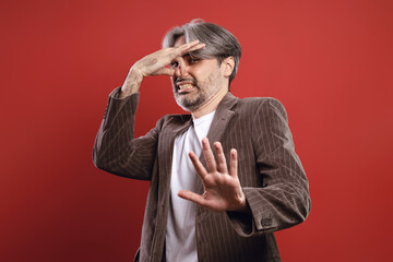 man with his hand on his nose