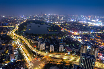 Stunning Night View of a Vibrant City Skyline with Water Reflection