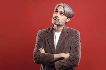 man with arms crossed looking up