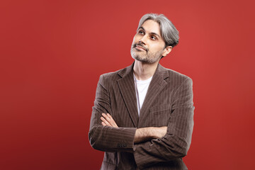 Fototapeta premium man with arms crossed looking up