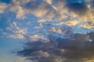 Dramatic pink and blue clouds fill the sky at sunset over a serene ocean