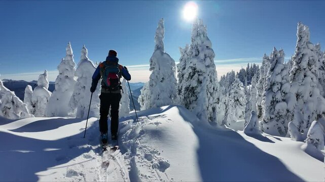Cross Country skier traversing high on mountain top
