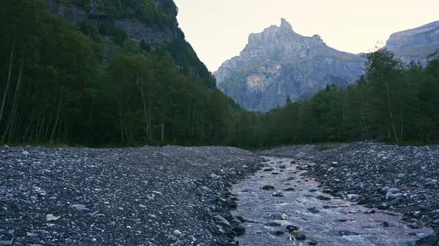Landscape of Cirque du Fer a Cheval with river flowing in the valley at Sixt Fer a Cheval, France