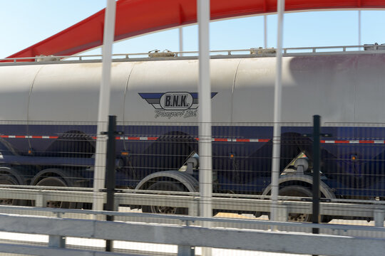a BNK Transport, a logistics and transportation company vehicle, trekking northbound over Cherry Street North Bridge in Port Area in Toronto, Canada