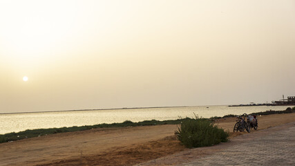 Golden Hour Serenity Bicycles by Tranquil beach from tunisia